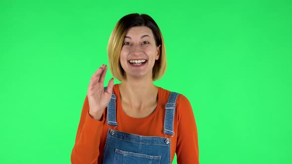 Happy Woman Waving Hand and Showing Gesture Come Here. Green Screen