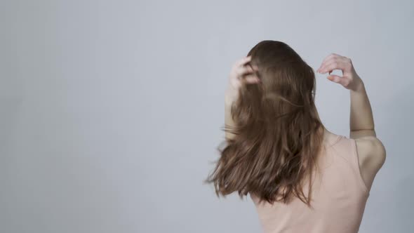 A Young Woman Shaking Her Healthy Hair