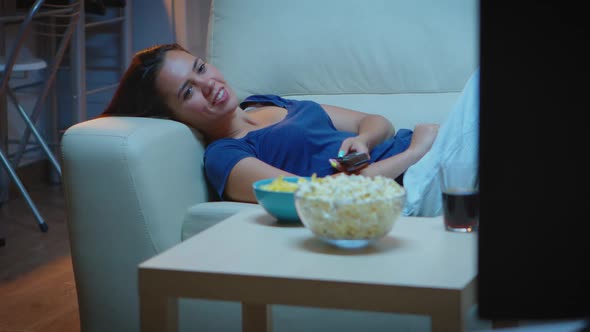 Woman Resting Lying on Couch in Front Tv