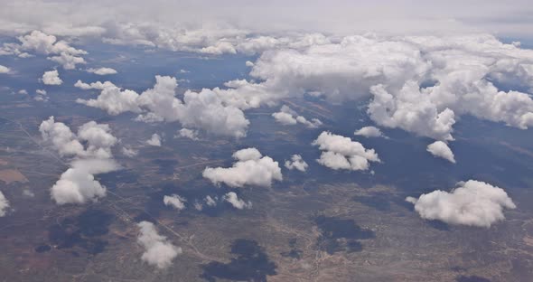 The View From the Plane of Fluffy Clouds in Desert Mountains From an Airplane New Mexico USA