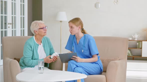 Young blonde doctor interviews short haired senior lady