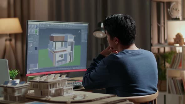 Engineer Thinking Then Raising Index Finger While Designing House On A Desktop At Home