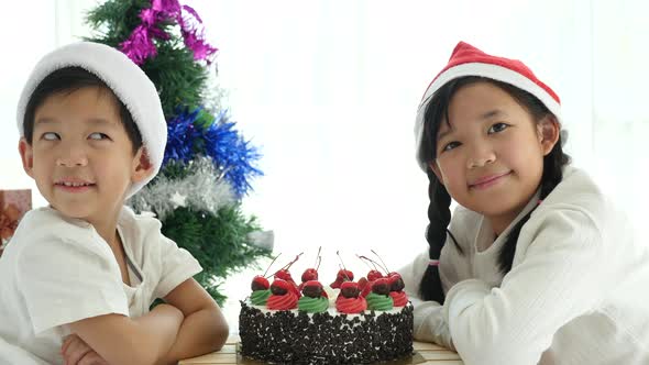 Happy Asian Children In Christmas Hat With Christmas Cake