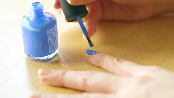 Female Doing Herself Blue Manicure