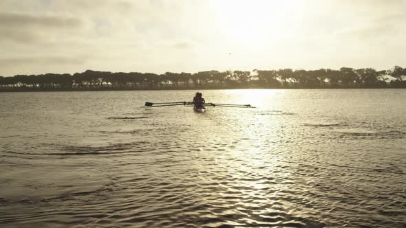 Female rowing team training on a river