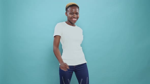 Happy Afro Girl with Short Haircut Dancing in Studio