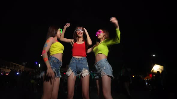 4K Group of Asian woman enjoy full moon beach party and dancing together.