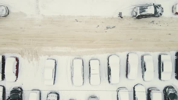 Many Cars in the Parking Lot Covered with Snow After a Blizzard