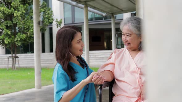 Asian female doctor caring for elderly patients.