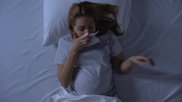 Exhausted Pregnant Female Suffering Nausea, Wiping Mouth With Tissue, Weakness