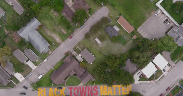 Bird eye view of a large "Black Towns Matter" sign painted on street in Houston Historical independe