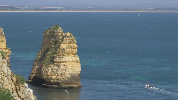 Boat sailing by a cliff in the sea