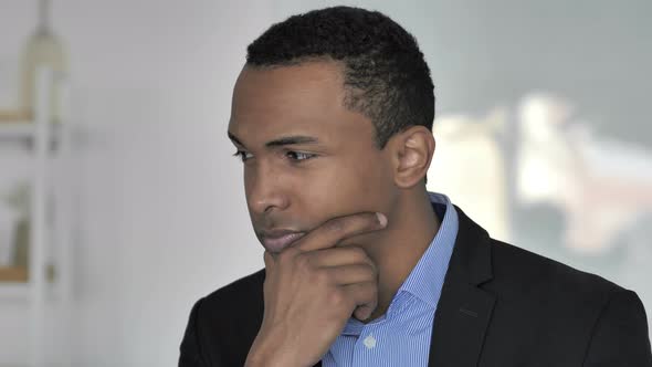 Depressed Casual Afro-American Businessman Thinking About Problems in Office