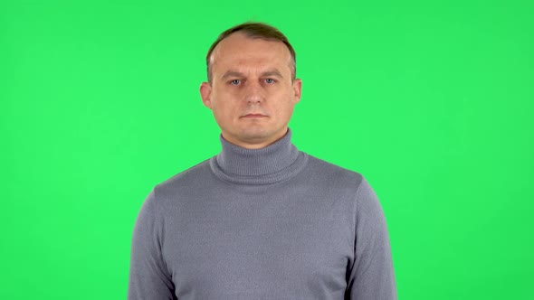 Portrait of Confident Man Is Looking at Camera. Green Screen