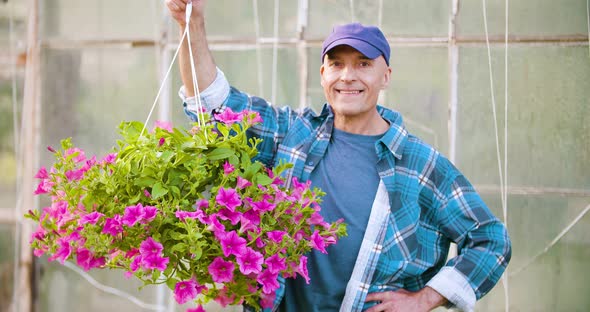 Agriculture Confident Male Gardener Examining Potted Flower Plant