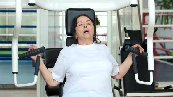 Tired Elderly Woman at Gym