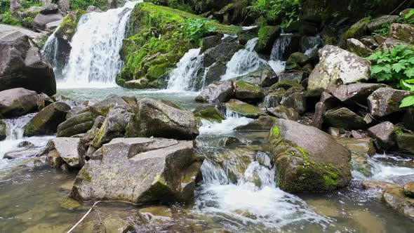 Mountain River Waterfall Flowing Between Rocky Shores in Carpathians Mountains Ukraine