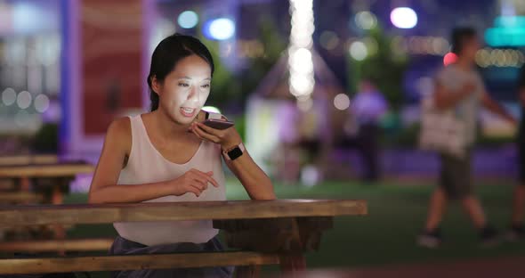 Woman use of mobile phone at outdoor cafe