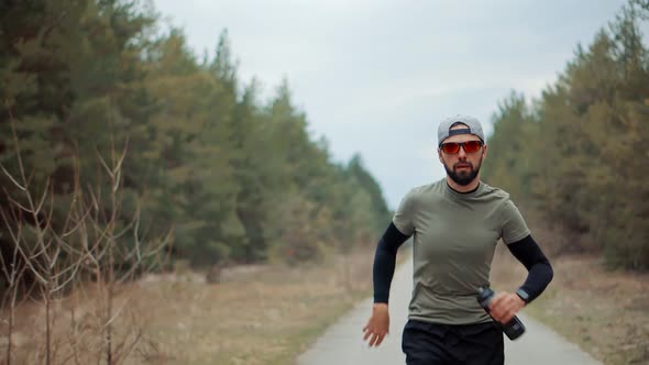 Running Man In Forest At Sunset.Runner Man Fit Athlete Legs Jogging On Trail Ready To Triathlon.