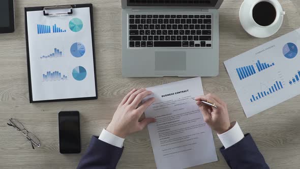 Head of Department Reading Business Contract Attentively, Top View of Workplace