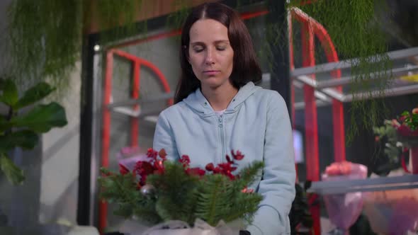 Portrait of Satisfied Florist Turning Floral Composition Smiling Standing in Workshop