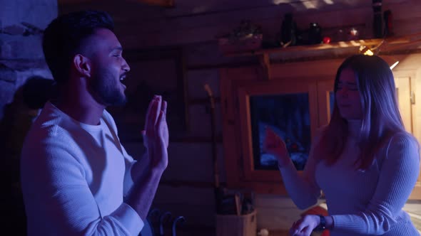 Happy Young Couple Dancing in the Wooden Hut on Valentines Day