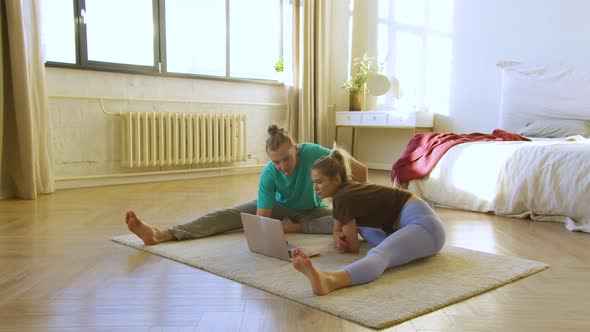 Young Couple Preparing to Stretching Workout at Home in Front of Laptop Monitor