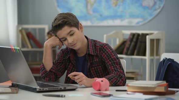 Teen Dreaming of New Gadget, Collecting Money in Piggy Bank, Financial Literacy