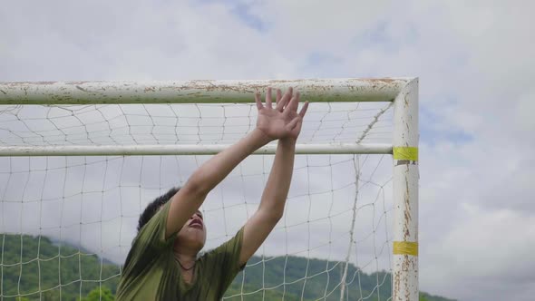 Young Goal Keeper Jumping And Save A Goal alt