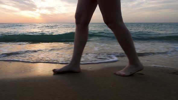 Close Up Woman Feet Walking on the Beach in the Water