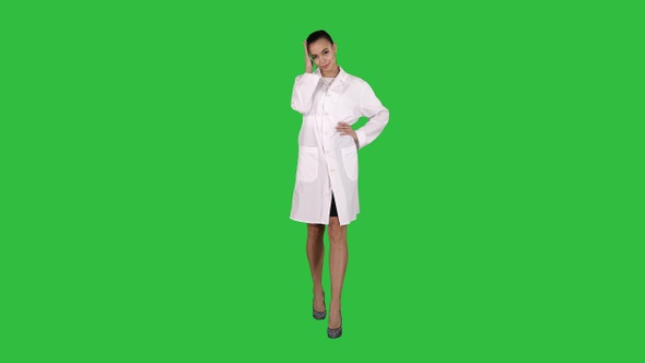 Woman doctor walking like fashion model on a Green Screen