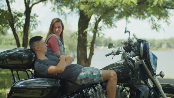 Relaxed Couple Talk on Motorcycle During Roadtrip