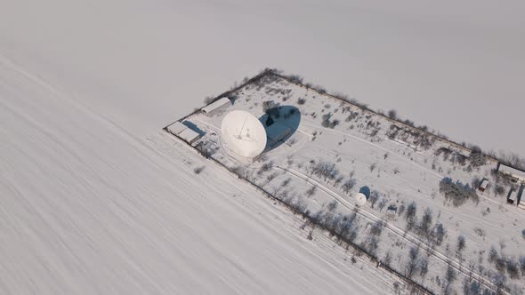 Aerial View of the Space Communication Station in Snow Covered Field at Sunny Winter Day Drone