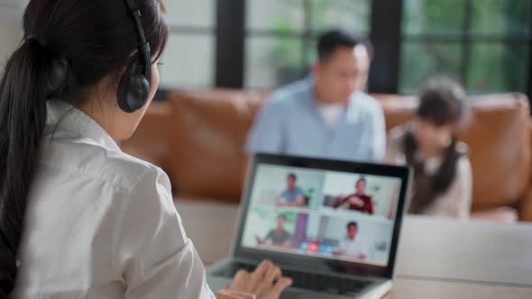 Asian business woman talking to colleagues team in video conference online meeting in video call.