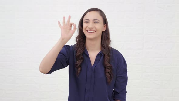 Indian girl showing Okay sign