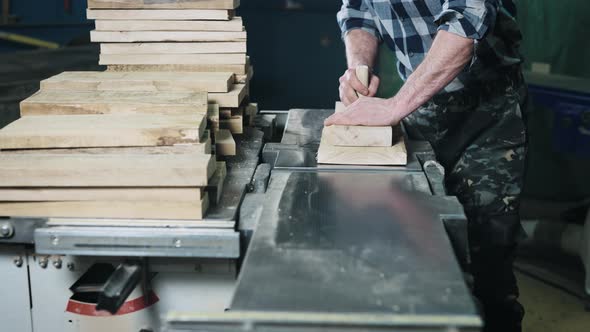 Closeup of Hands and Wood Workpiece on Planer