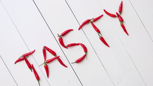 A Word TASTY Formed with Small Red Chilli Peppers