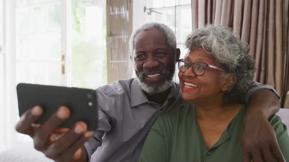 A senior african american couple spending time together at home taking a picture social distancing i