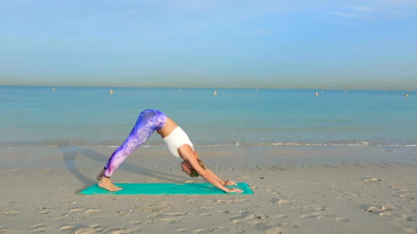 Woman Doing Yoga by the Sea