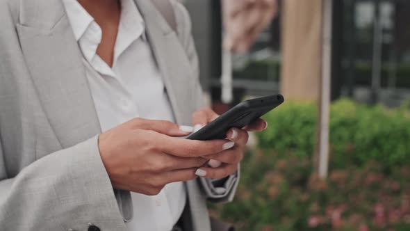 Unrecognizable Businesswoman Typing on Mobile Phone