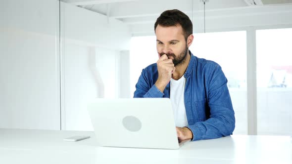 Thinking Beard Man Working on Laptop Creating New Innovative Ideas