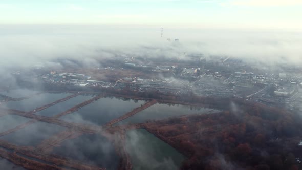 Aerial Drone View Flight Over Above Fog Mist and Roofs of Buildings in City