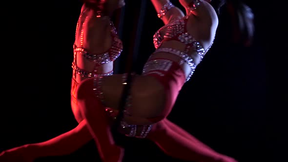 Two Woman in Makes Element in the Aerial Hoop. Black Background. Slow Motion. Close Up