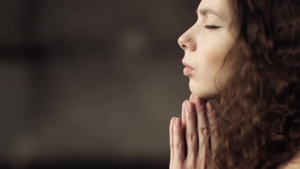 Close-up of the Meditating Girl. Beautiful Curly Hair. The Girl Is in a State of Relaxation