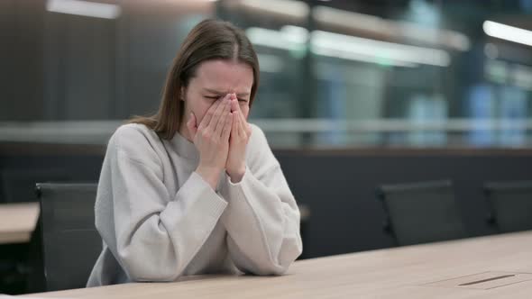 Upset Woman Crying While Sitting in Office
