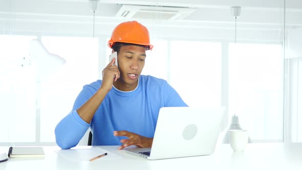 Architectural Engineer Talking on Phone, Attending Call at Work