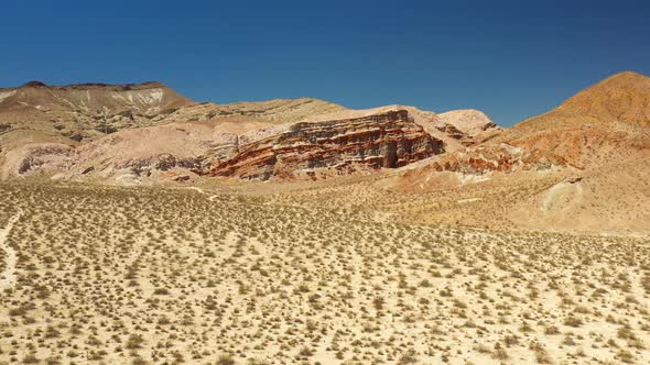 The amazing geological sandstone formations in the Mojave Desert created by erosion - aerial flyover