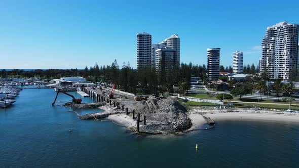 Coastal land project with a silt barrier set up preventing contaminants from entering the water arou