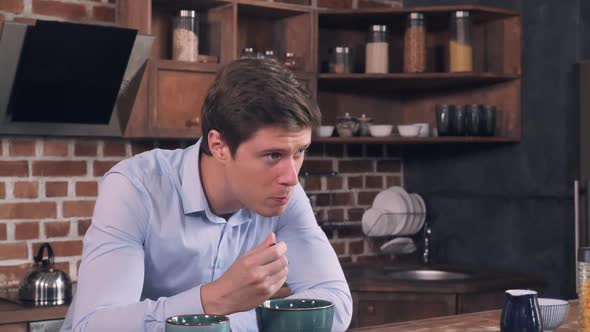 Thoughtful Men Eats in Apartment