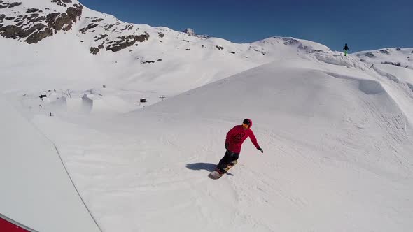 A young man snow boarding.